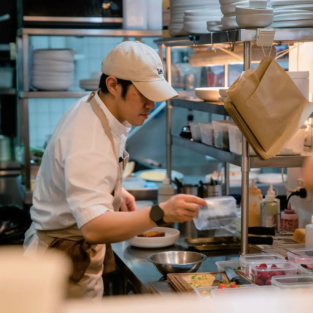 A Prologue chef plating at the pass in the open kitchen