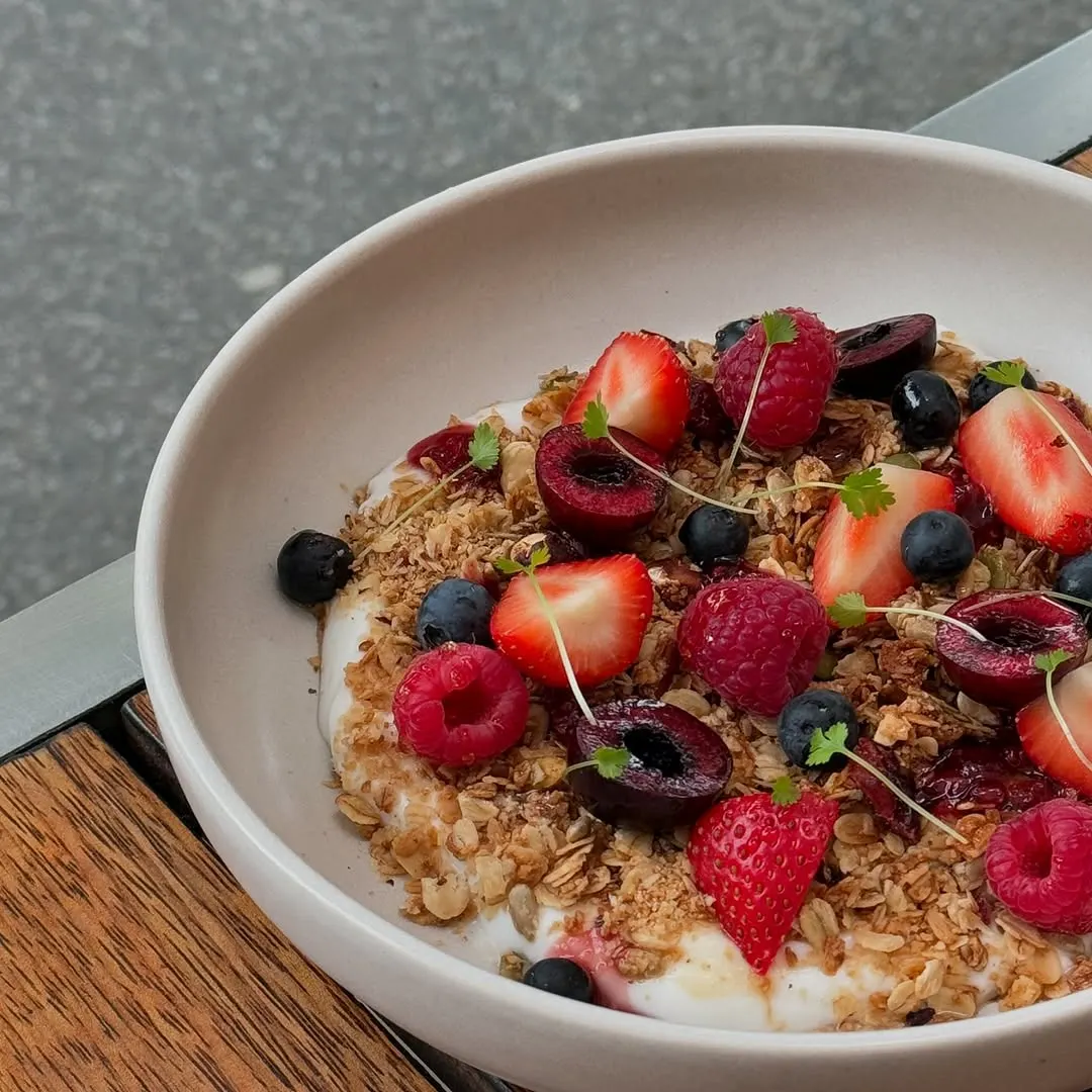 House granola with yoghurt, stone fruit and fresh berries