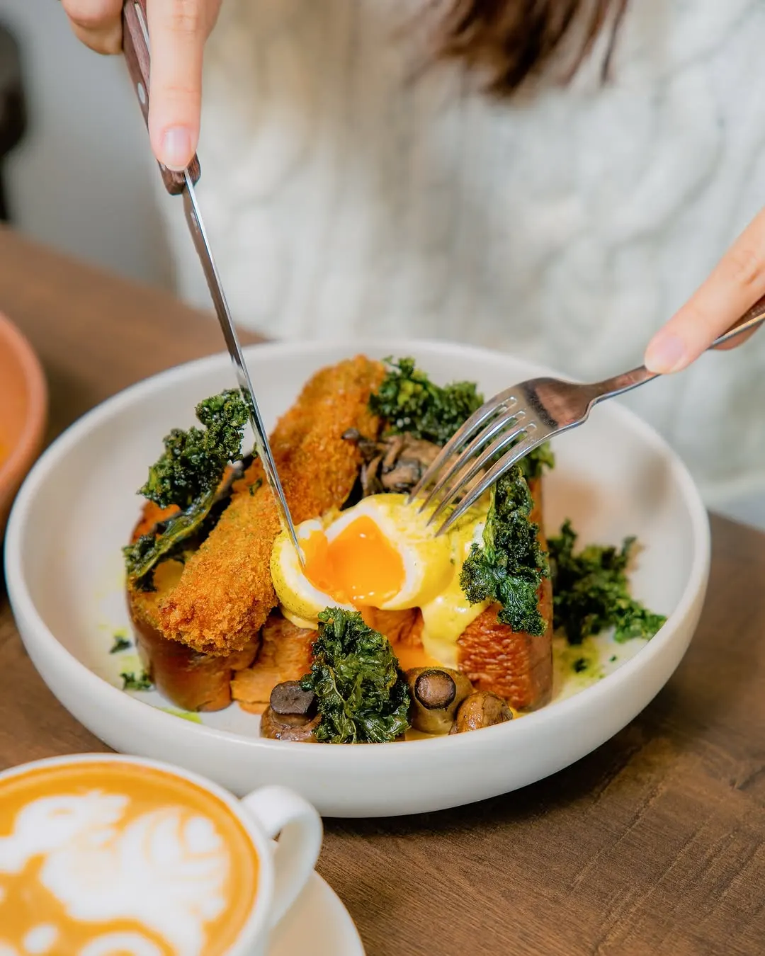 Wild mushroom benedict with crumbed egg, kale and curry hollandaise