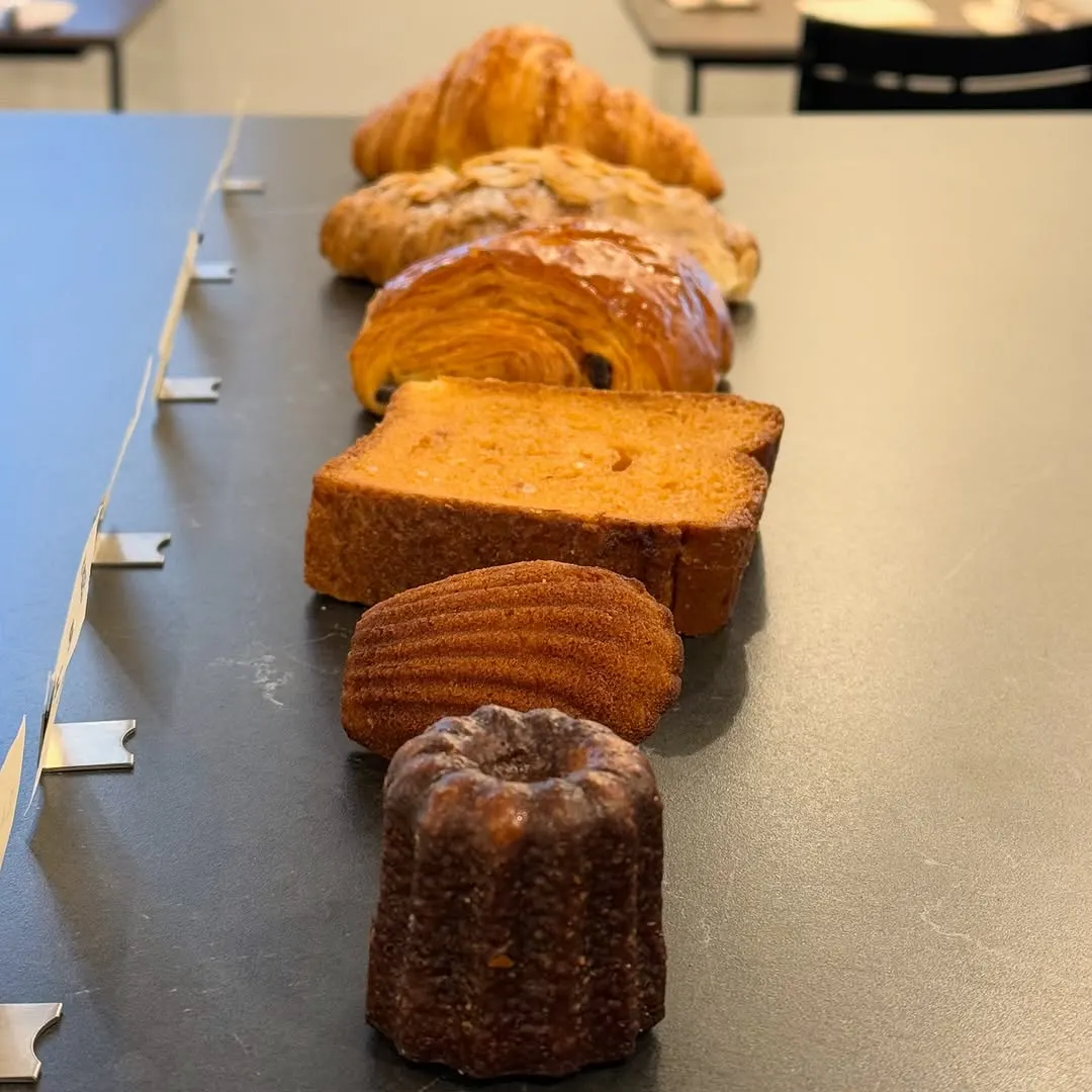 A line-up of croissants, almond croissant and pain au chocolat